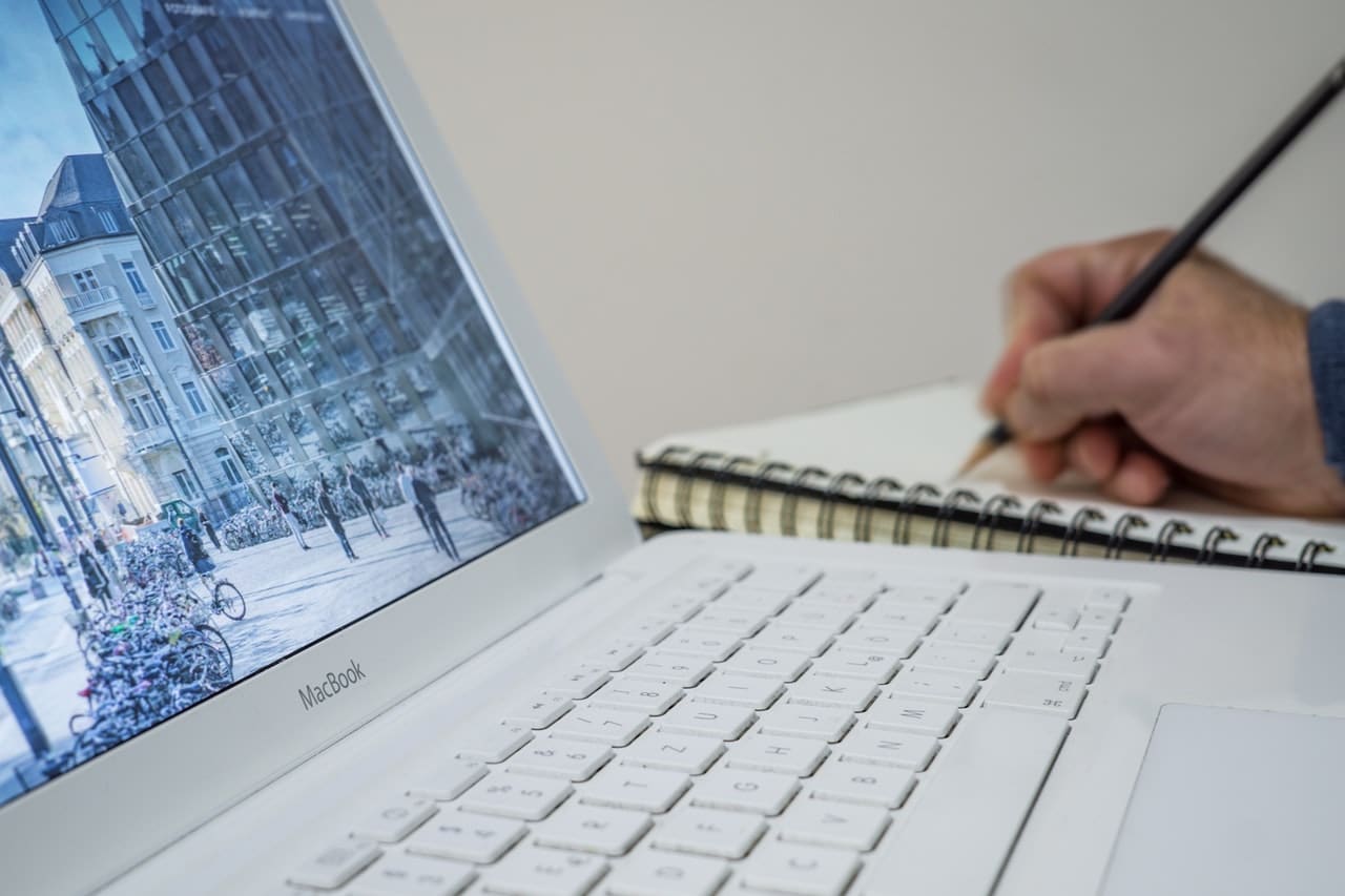 man writing on a notebook