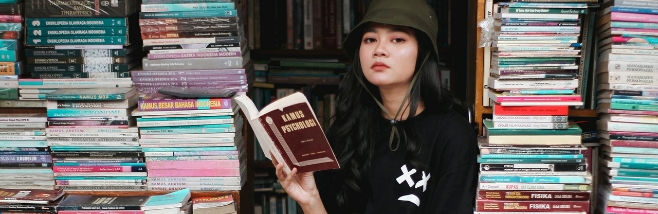 girl reading a book in a store