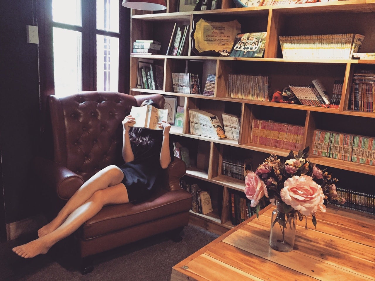 girl reading a book in a couch