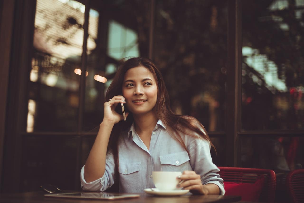 girl speaking on the phone in a bar