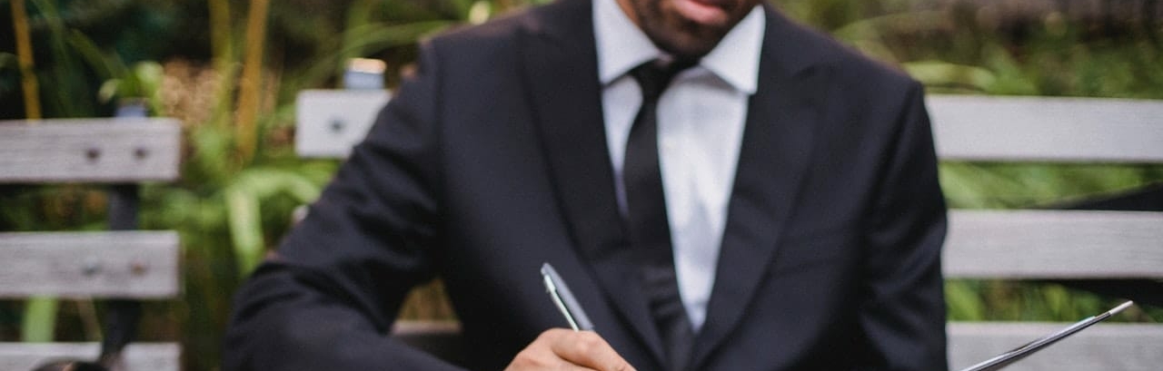 man in a suit writing