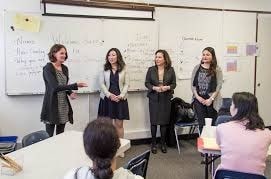 women-speaking-in-front-of-an-audience