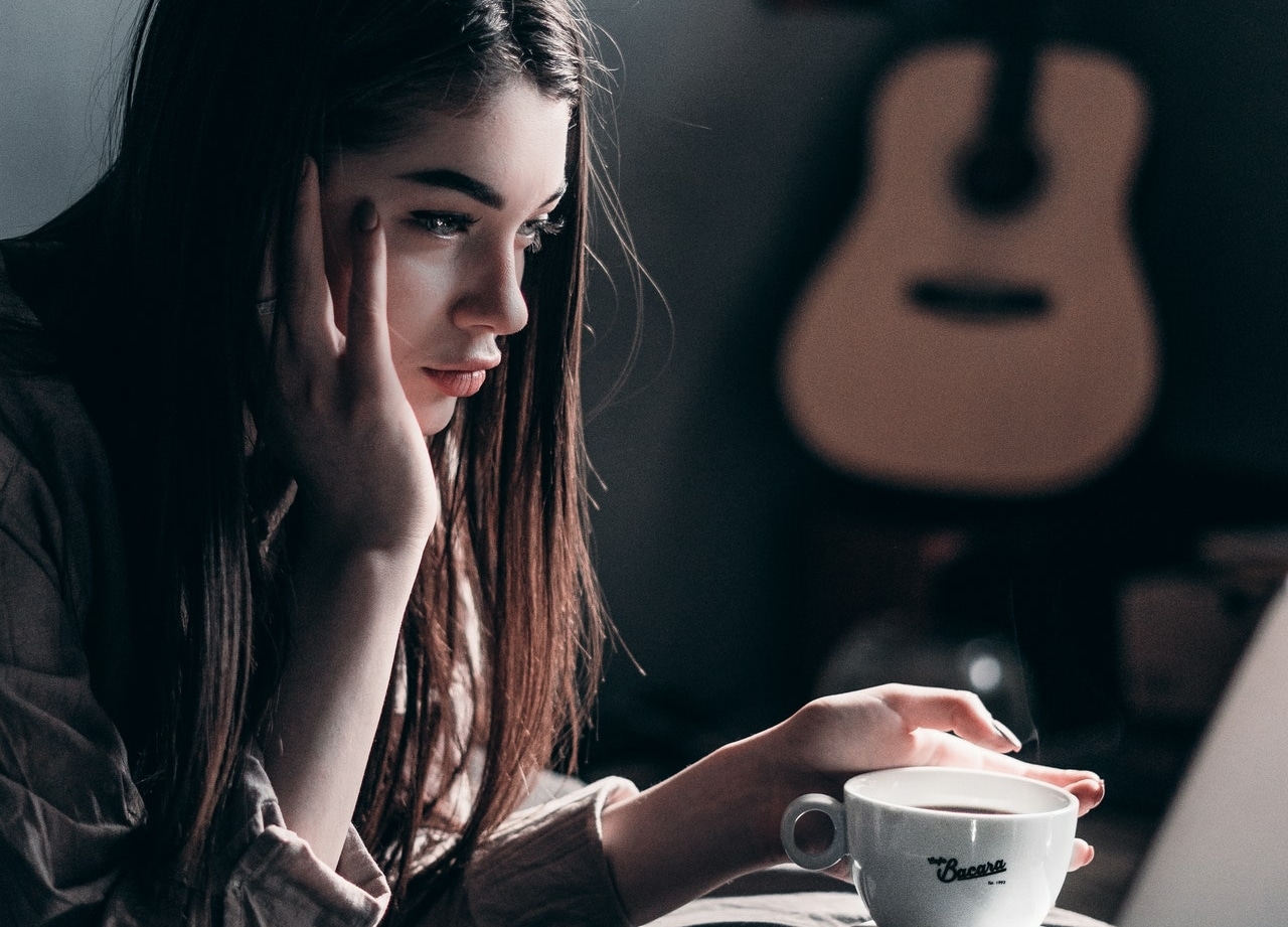 girl thinking with a cup of coffee