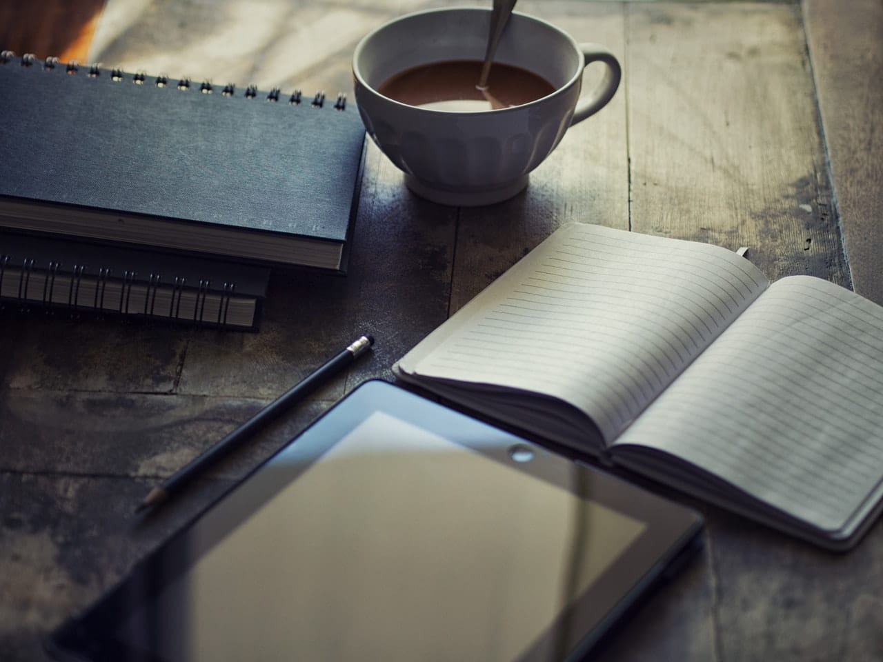 notebooks and coffee on a table