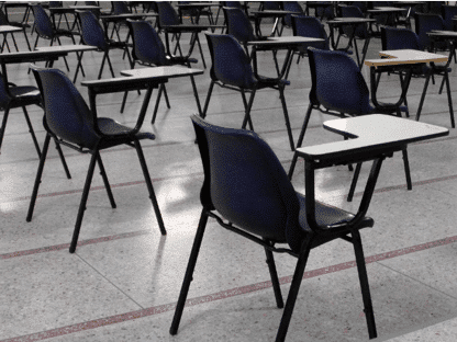 Chairs and desk in an IELTS test center.