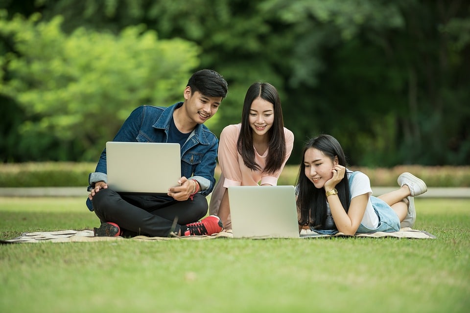 a family outside using their computers