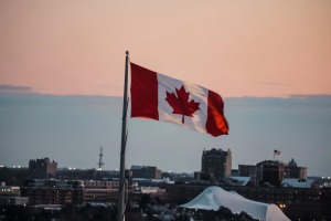 canadian-flag-waving-with-the-city-behind