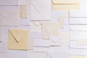 Several white and yellow envelopes on a table.
