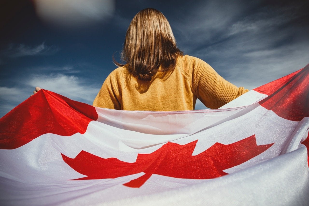 canadian flag behind a woman's back