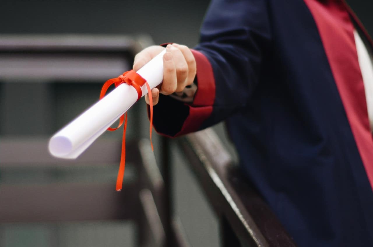 man holding a diploma