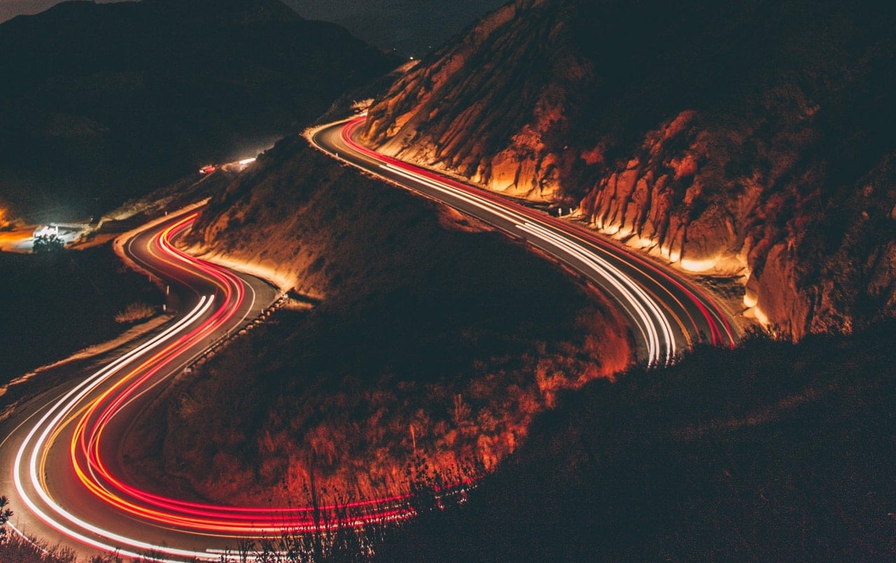 city car lights at night in the mountains