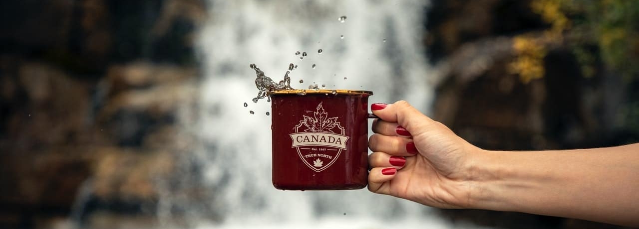 person holding a cup with canada written on it