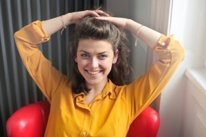 women-smiling-with-arms-hanging-hair