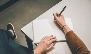 hand-that-is-writing-in-a-notebook