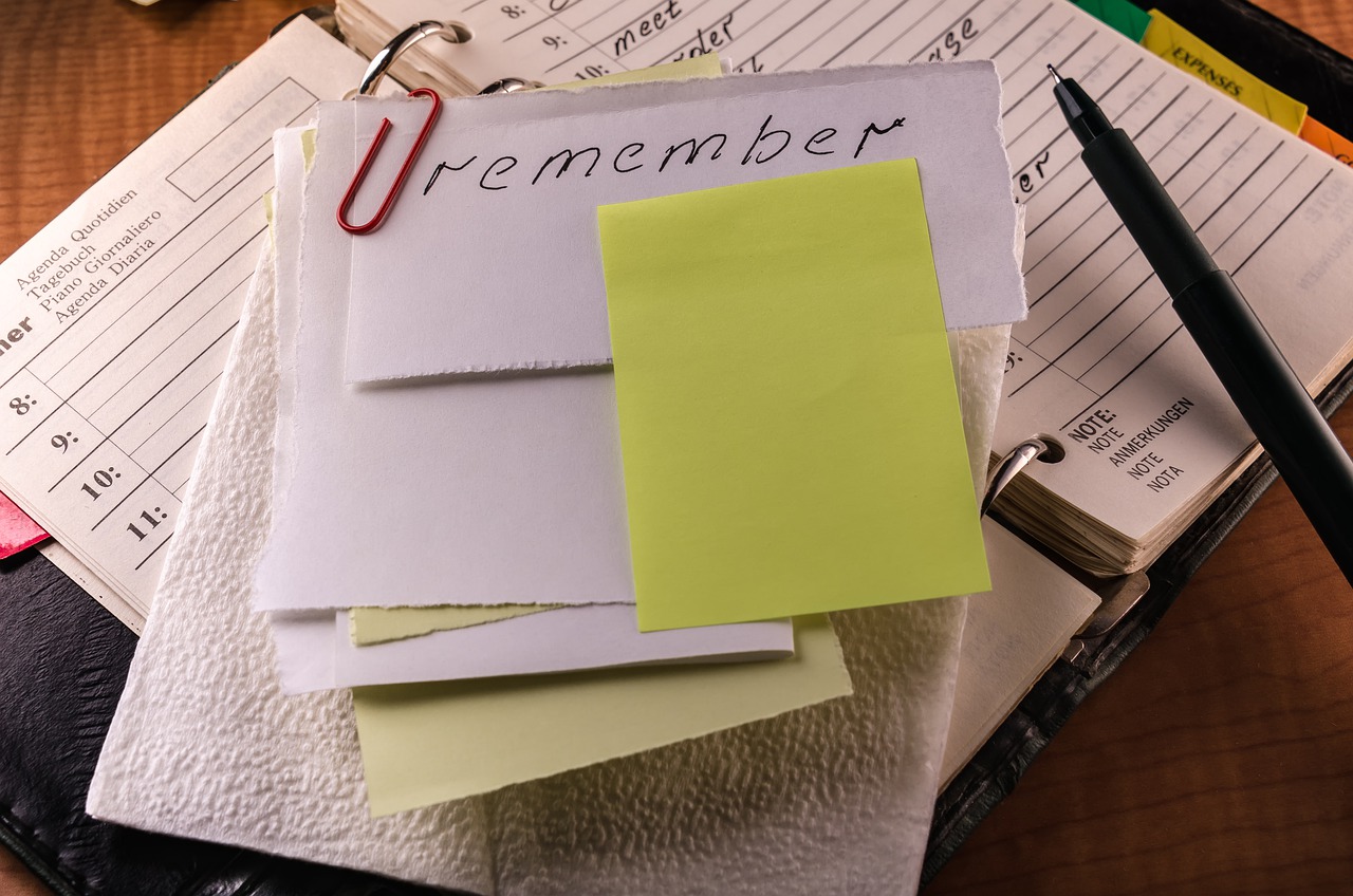 a pile of papers notes and notebooks