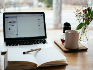 a-book-a-computer-and-a-cup-of-coffee-on-a-table