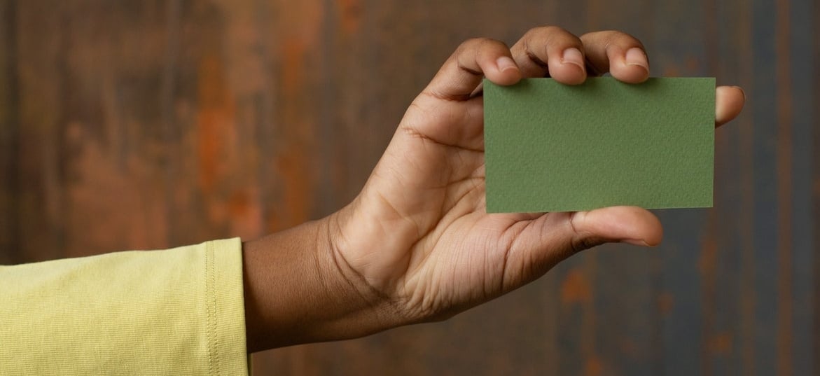 person holding a green card