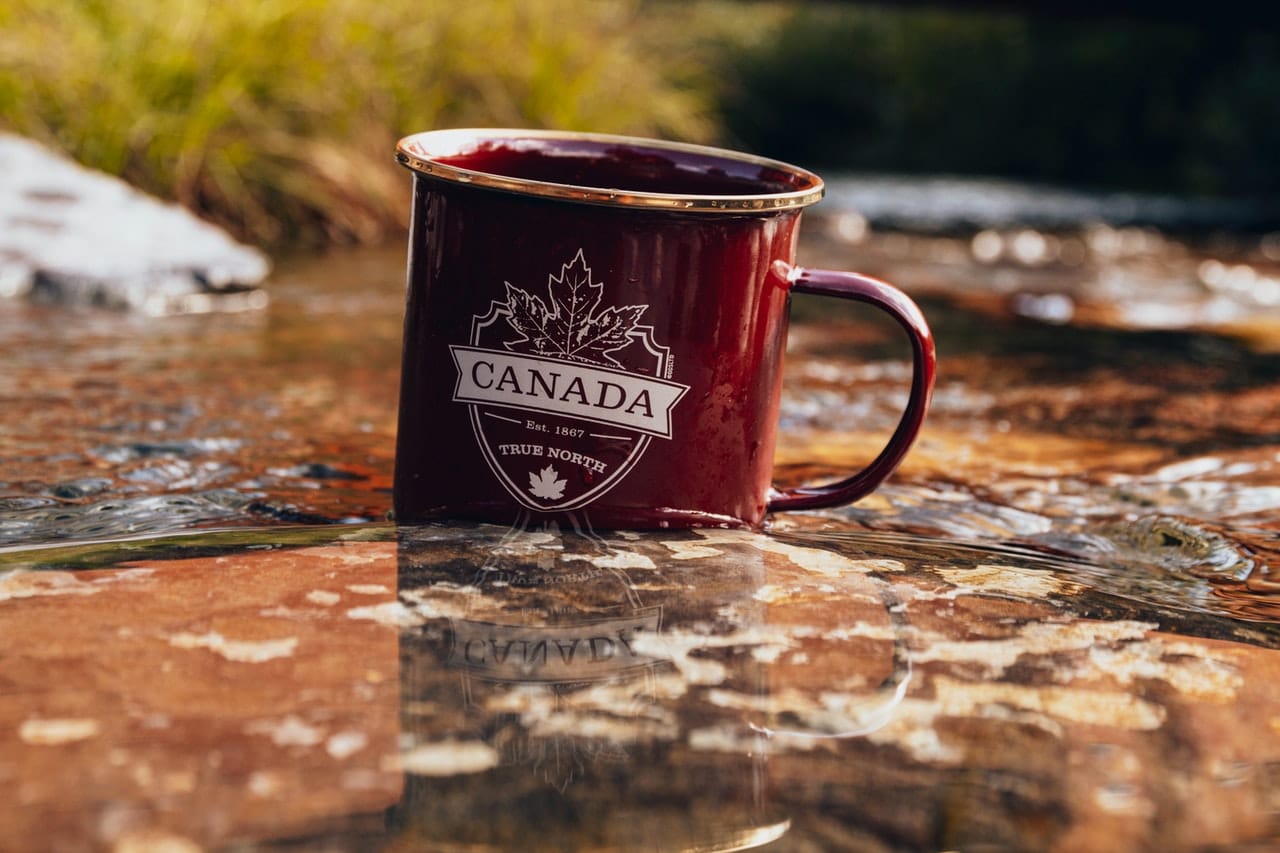 mug with canada inscriptions in the river