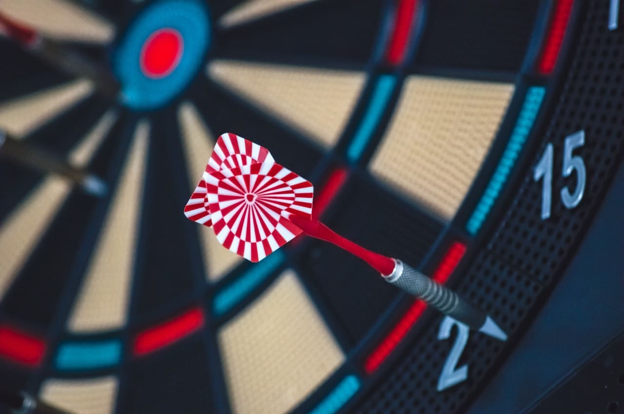 a darts arrow in a darts board