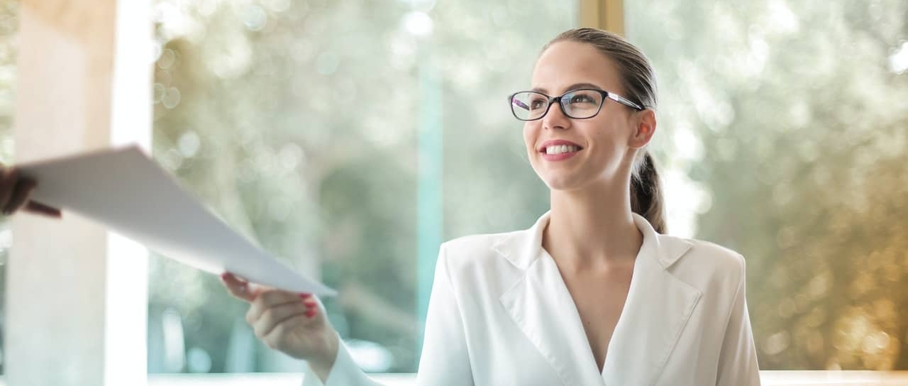 woman handing out a document