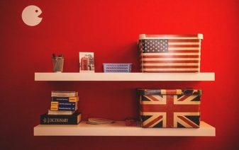 american and english flag boxes and books on shelves