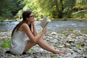 girl-reading-along-a-river