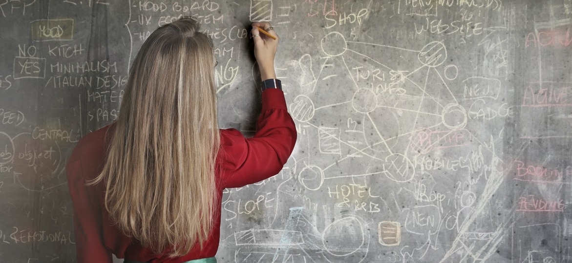girl writing on blackboard