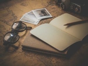 glasses-photos-copybooks-on-a-map
