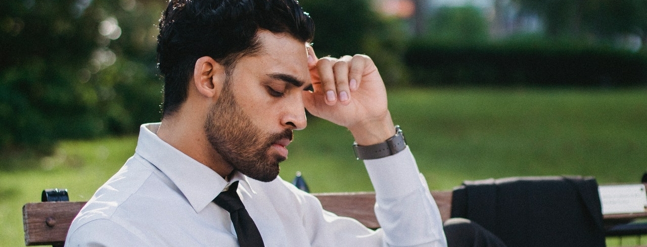 bearded man in a suit thinking