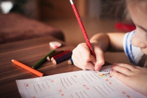 little-girl-writing-on-a-sheet-of-paper