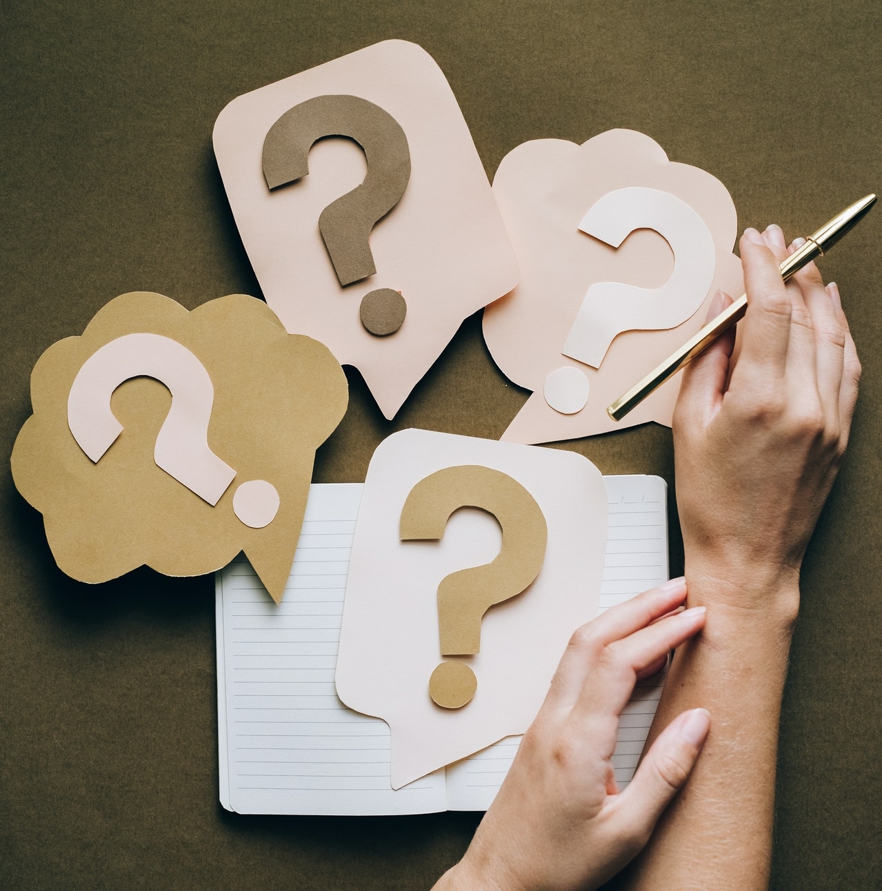 cardboard question marks on a table