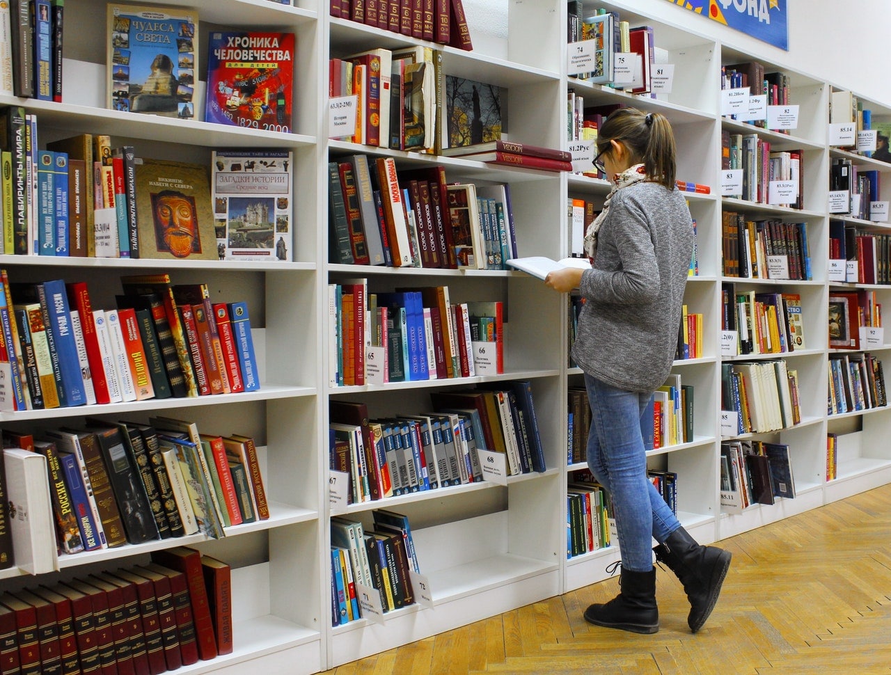 woman choosing books in a library