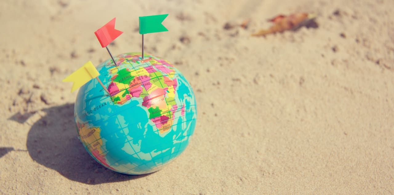 world globe on sand
