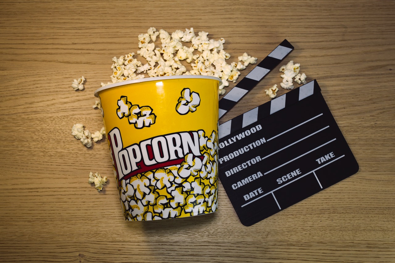 a bag of popcorn and a clapperboard