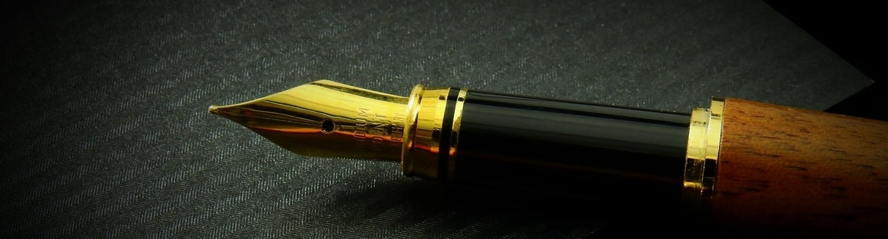 a calligraphy pen on a black piece of paper