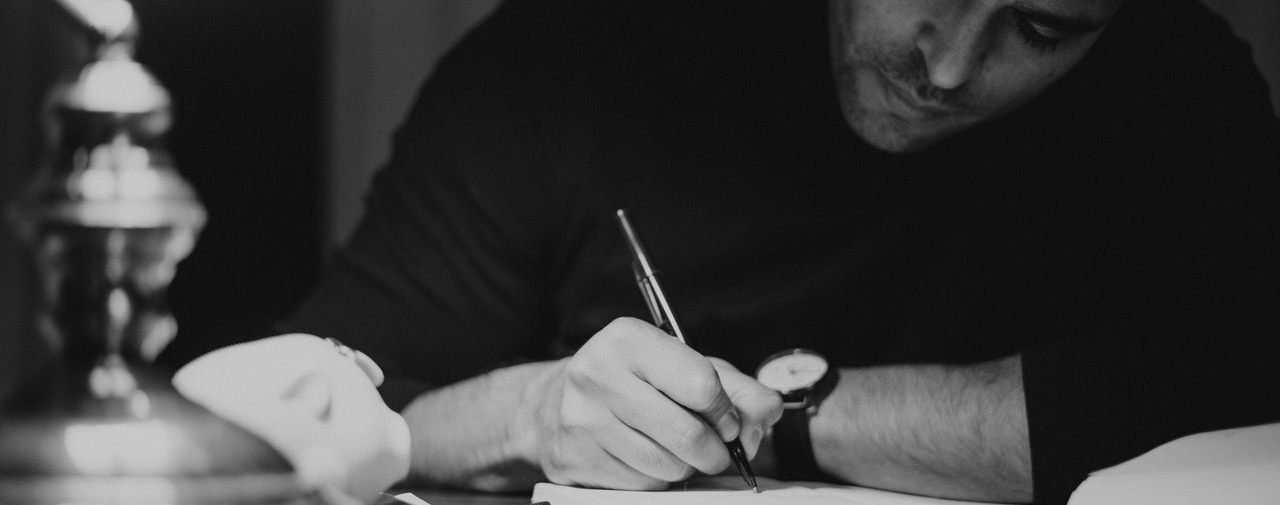 a man writing in a notebook