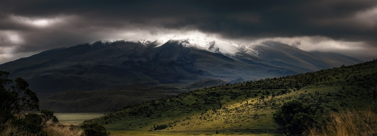 green landscape with a cloudy sky and stormy weather